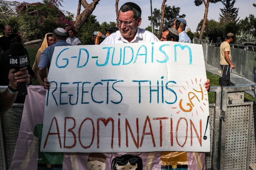 Opponents of the Jerusalem Pride parade hold up placards condemning LGBTQ rights