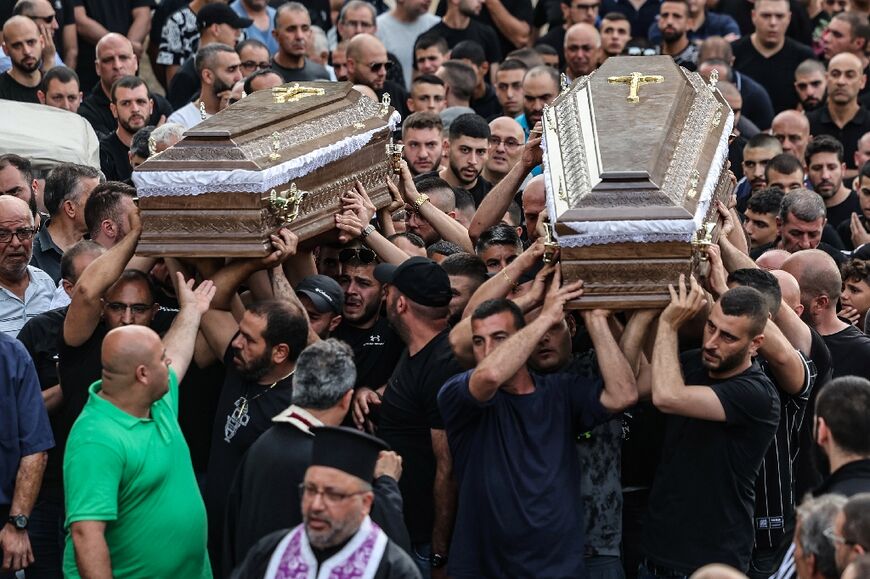 Mourners carry the coffins of two of the five Arab Israelis killed a day earlier in the village of Yafia