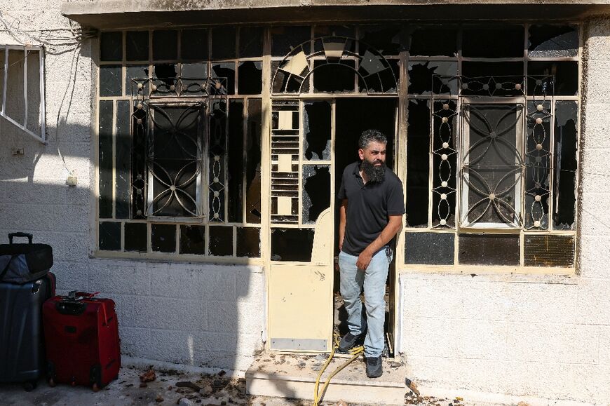 A man prepares to leave his home taking a few suitcases with him after it was set on fire by Israelis in Turmus Ayya, in the occupied West Bank