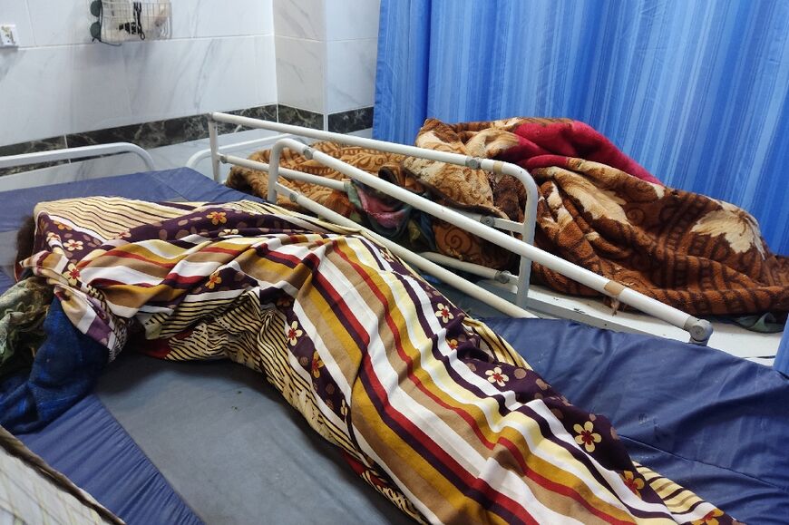 The bodies of victims, killed when an artillery shell struck their house, lie at a hospital in southern Khartoum 