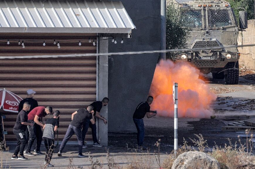 An explosive charge left by Palestinians detonates near an Israeli armoured vehicle in Jenin