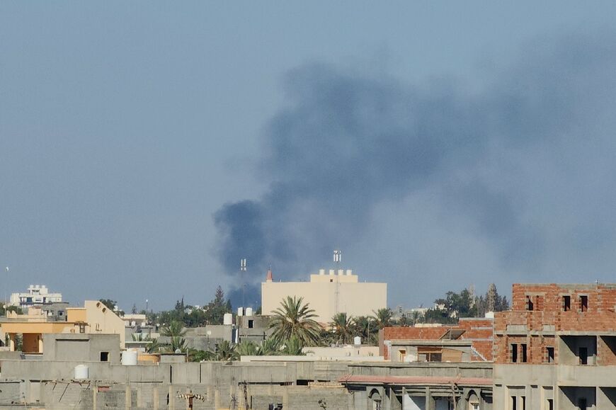 Smoke billows over the Libyan capital amid heavy fighting between the two main armed groups linked to the Tripoli-based government