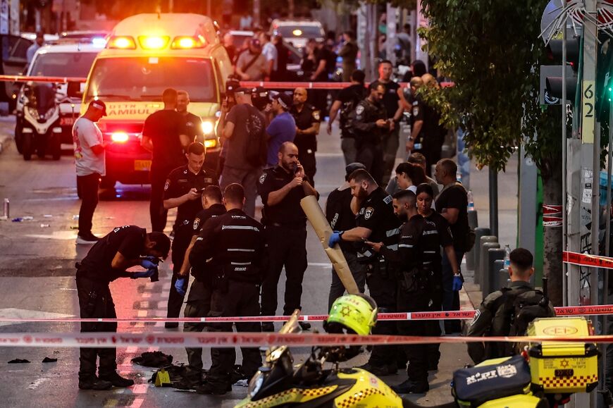 Israeli police gather evidence from the scene of a shooting in commercial hub Tel Aviv which criticially wounded an Israeli