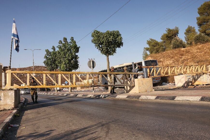 Israeli security forces man a checkpoint at the closed-off southern entrance to Hebron