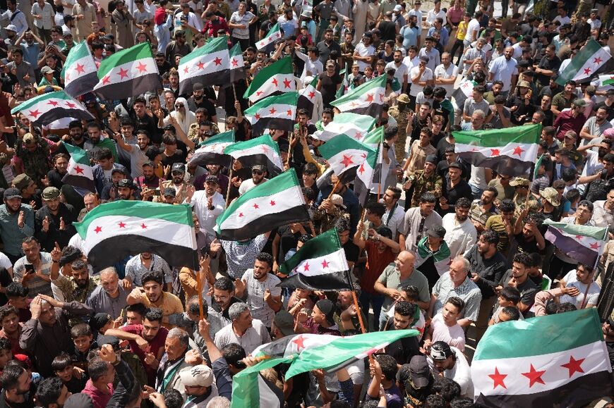 Syrians in the rebel-held northern city of Azaz demonstrate in solidarity with the protesters in the government-ruled south