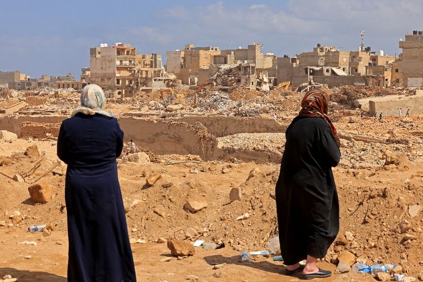 Survivors look at the rubble of destroyed buildings in Libya's eastern city of Derna 