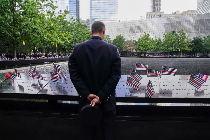 A New York firefighter looks at September 11 victims' names inscribed at the New York memorial on the 22nd anniversary of the 2001 Al-Qaeda terror attack 
