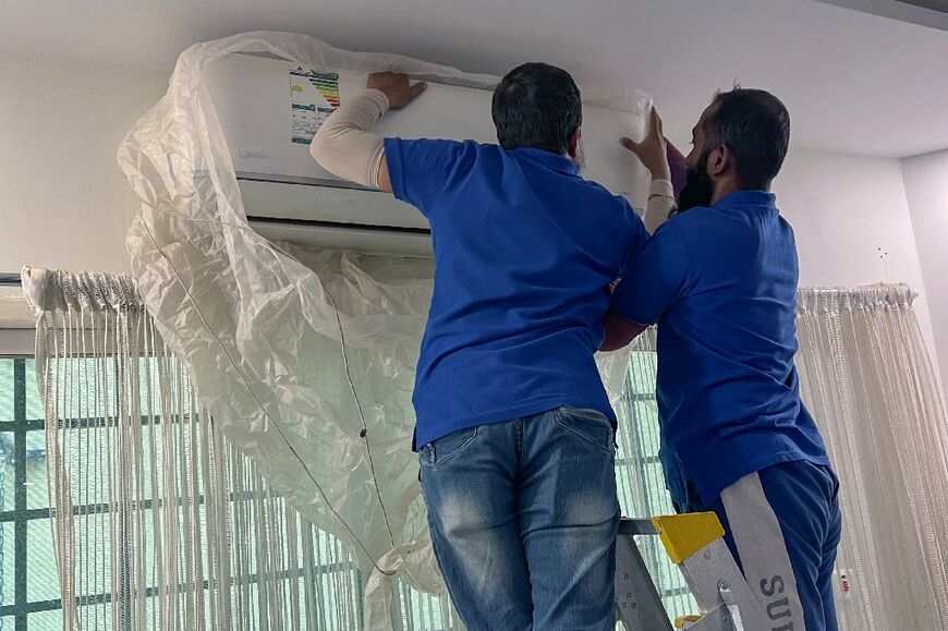 Technicians try to work inside during the hottest part of the day