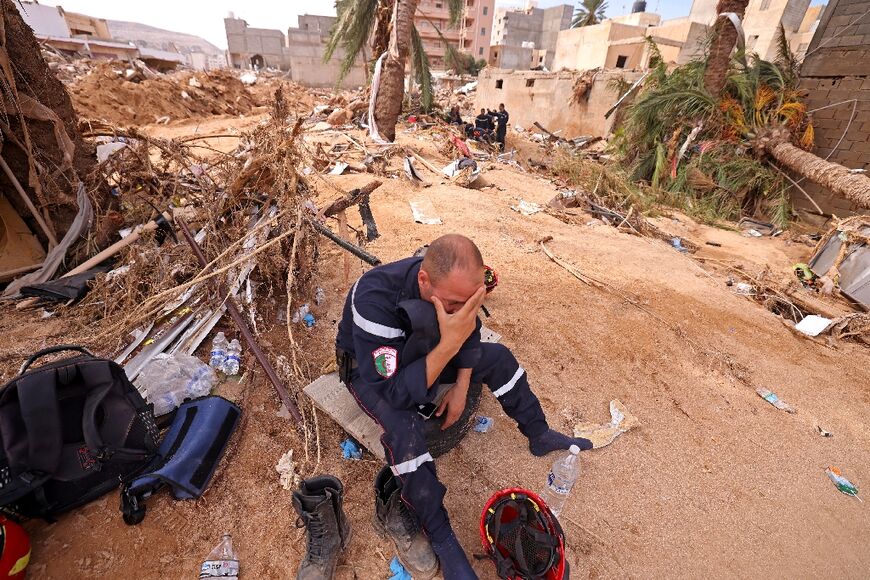 A member of an Algerian rescue team seen against the background of devastation in Derna where aid workers from several countries are trying to search for bodies or survivors