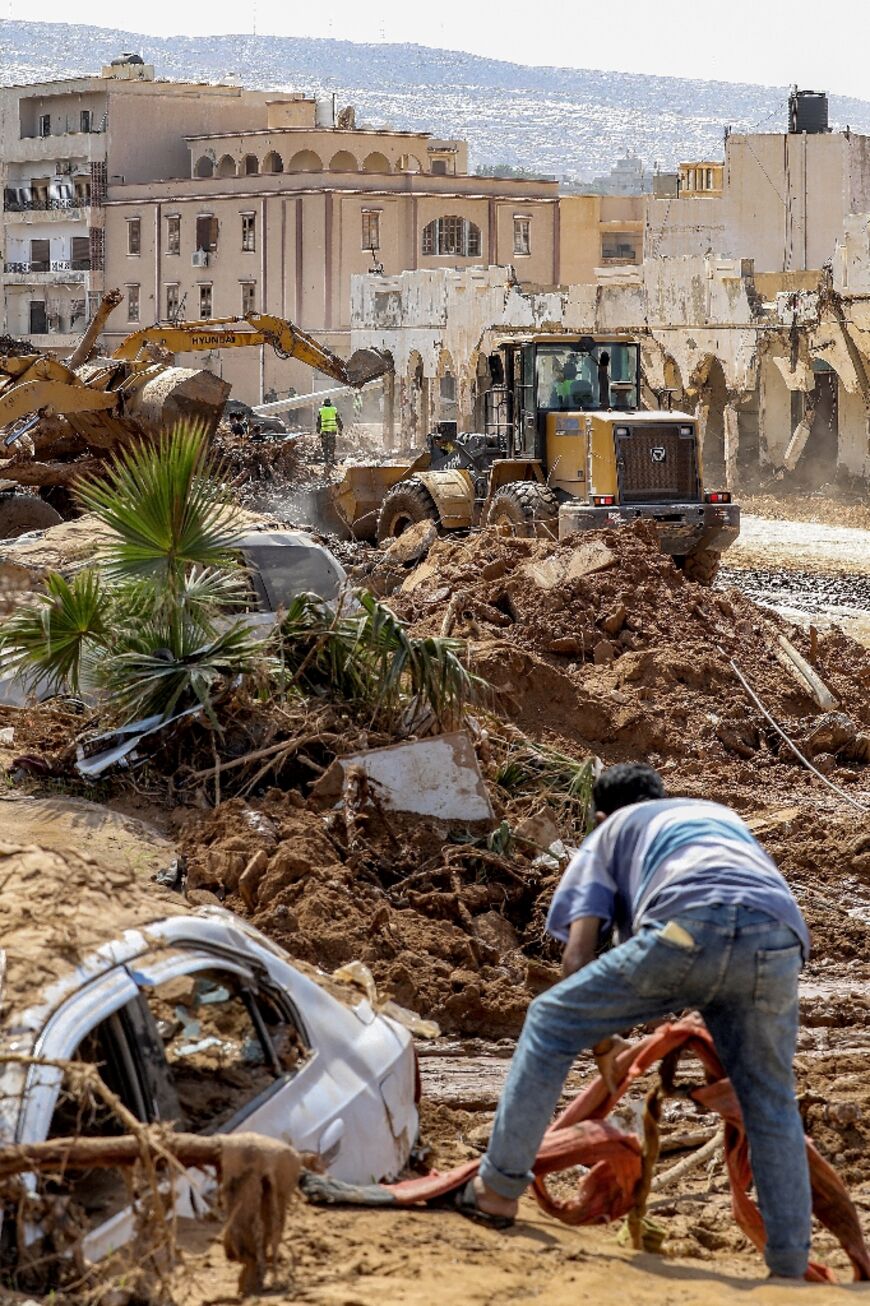An excavator clears debris in Libya's eastern city of Derna