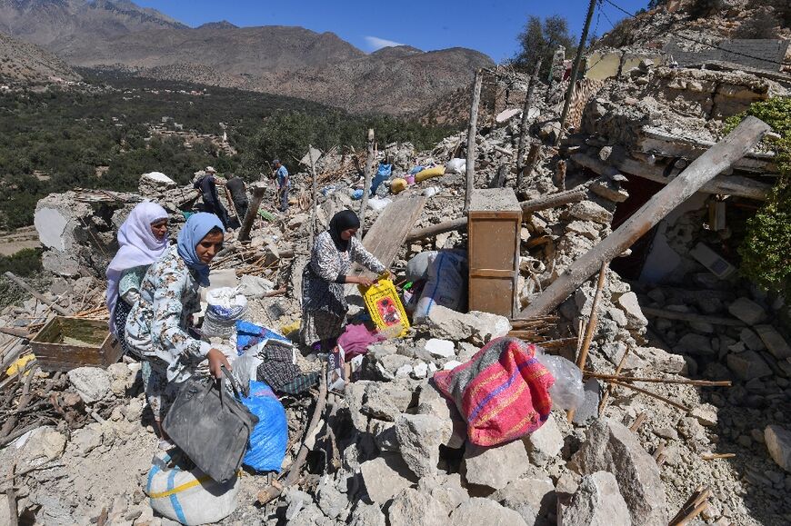Residents salvage belongings from the rubble of Imoulas village in Taroudant province, one of the most devastated in quake-hit Morocco