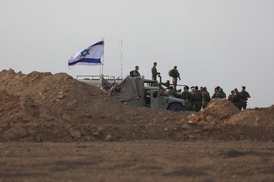 Israeli troops gather near the border with Gaza before entering the Palestinian strip on October 29, 2023