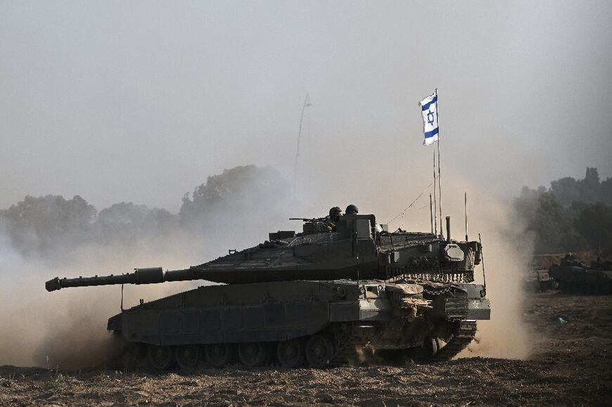 An Israeli tank deploys to the Gaza border