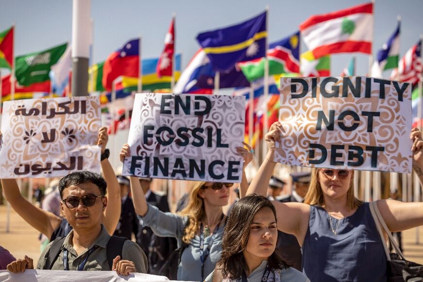 A dozen activists protested outside the IMF meetings, holding a banner that read "World Bank end fossil finance" 