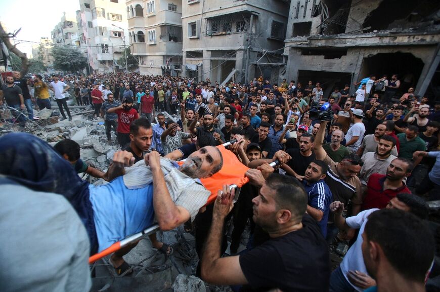 Palestinians evacuate a wounded man from the site of an Israeli strike on Gaza City on Tuesday
