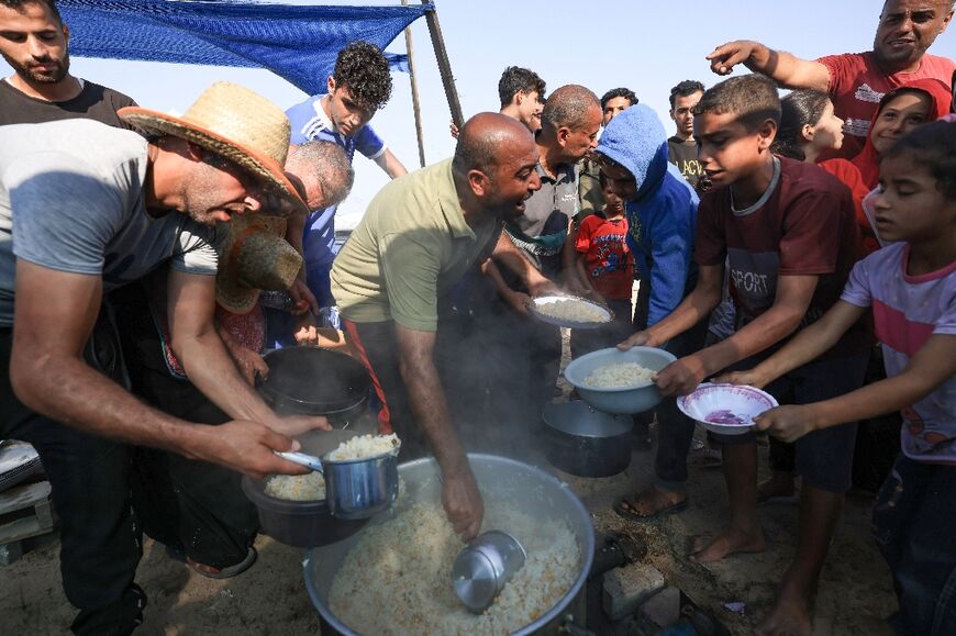 Food is distributed at a camp for displaced people in the south of the Gaza Strip
