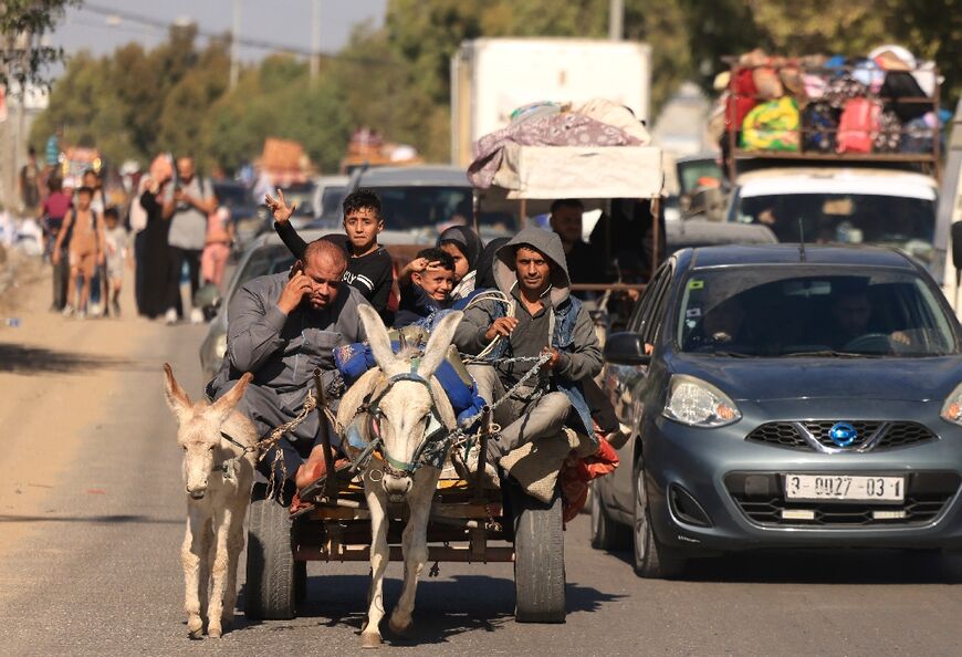 Riding a donkey drawn cart as family along with hundreds of other Palestinian carrying their belongings flee following the Israeli army's warning to leave their homes and move south before an expected ground offensive