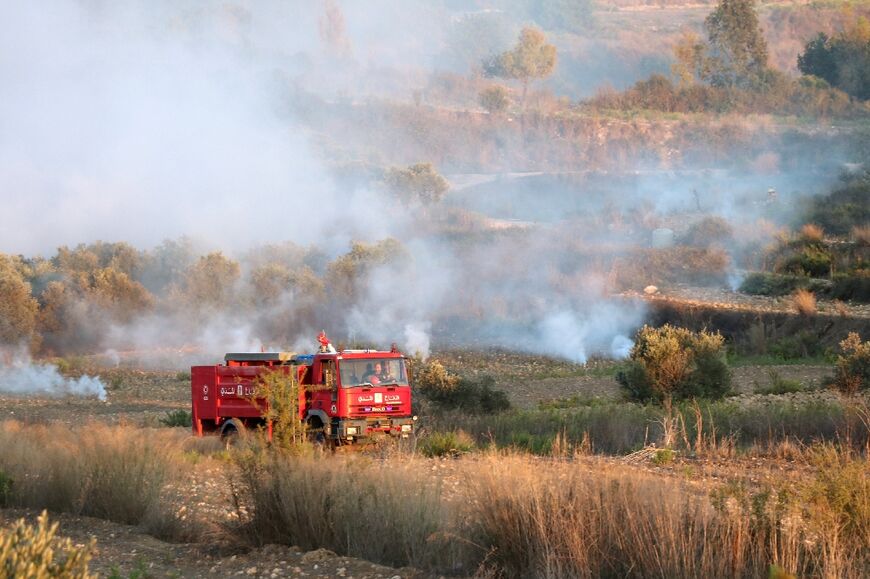 Lebanese firefighters deploy near the  southern village of Dhayra after it came under Israeli bombardment on Monday