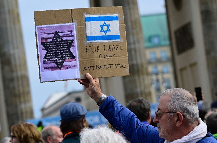 A man with a placard reading "For Israel - against anti-Semitism" at the Berlin rally