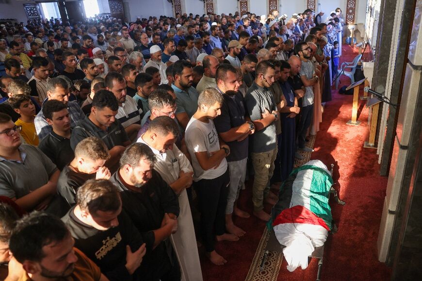 Mourners attend the funeral of Hamas member Zakaria Muammar, who was killed in an Israeli strike, in Khan Yunis, the Gaza Strip