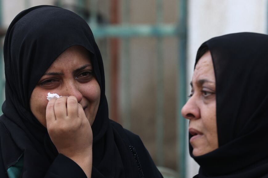 Palestinians in Gaza City mourn during the funeral of a relative, killed in an Israeli strike