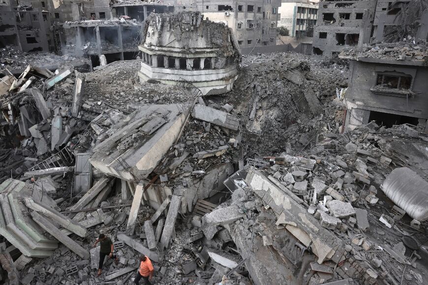 Palestinians inspect the destruction around Ahmed Yassin mosque, which was levelled by Israeli airstrikes, in Gaza City early on October 9, 2023