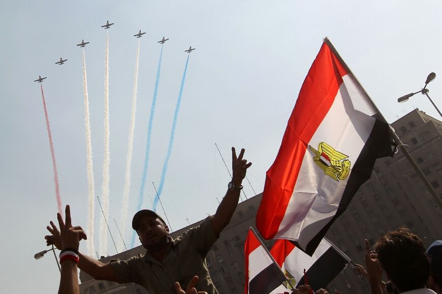 Egyptian air force jets fly over Tahrir Square in Cairo during a ceremony marking the 38th anniversary of the 1973 war