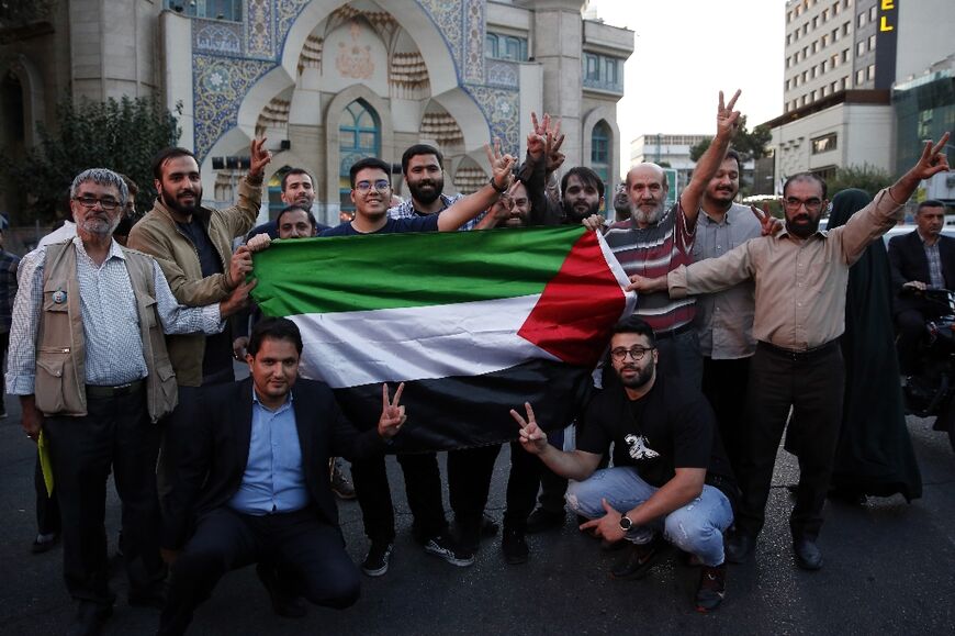 Iranians attend a gathering to express solidarity after Hamas militants launched a deadly air, land and sea assault into Israel from the Gaza Strip