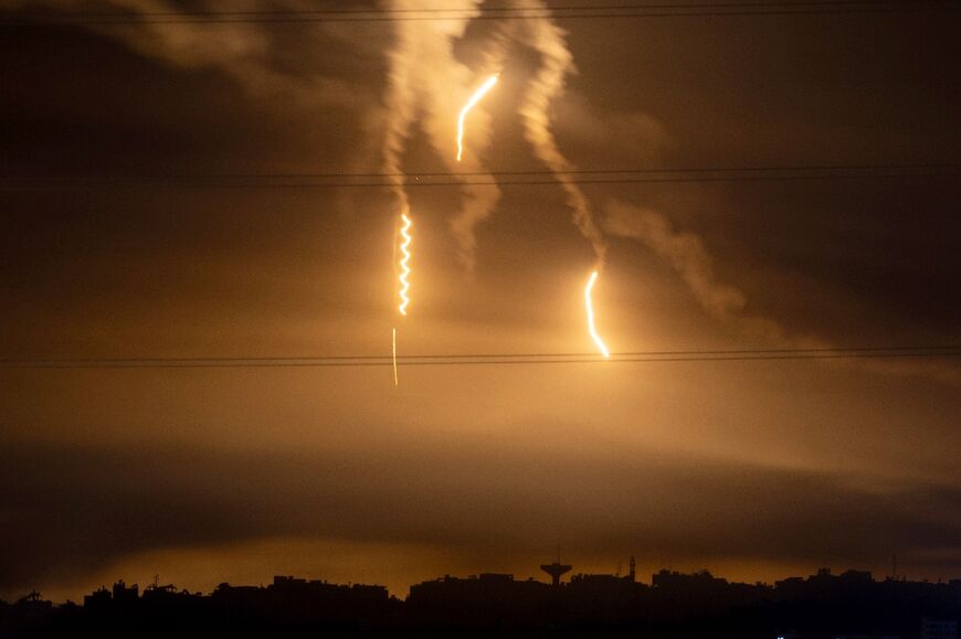 Flares launched by Israeli forces light the sky above the northern Gaza Strip