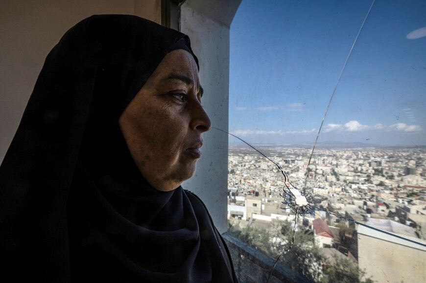Eman Sabbagh beside the window with the bullet hole