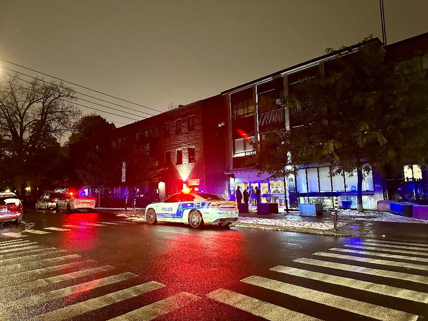 Police cars sit in front of Talmud Torah Elementary School as parents pick up their children in the Cote-des-Neiges neighborhood of Montreal after it and another area Jewish school were hit by gunfire, amid tensions in Canada over the Israel-Hamas war
