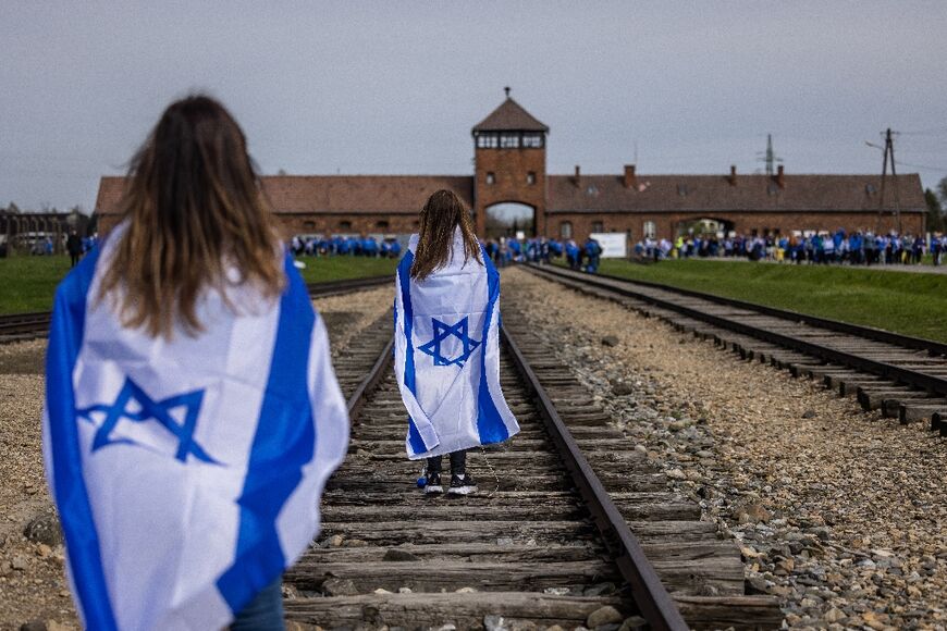 Participants in the annual March of The Living walk along the train tracks to the Birkenau camp, part of the former Auschwitz-Birkenau camp at the village of Brzezinka near Oswiecim, Poland on April 18, 2023