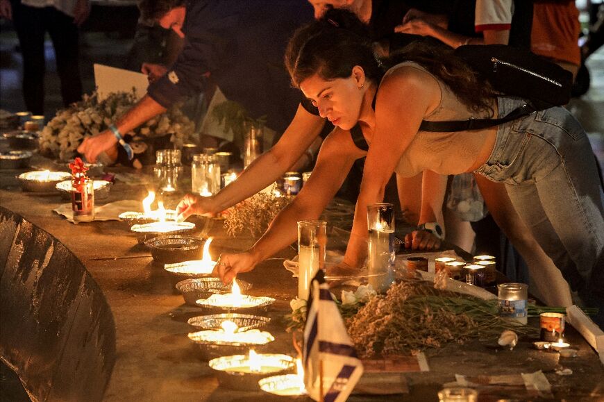 People light candles at a vigil for the hostages in Tel Aviv