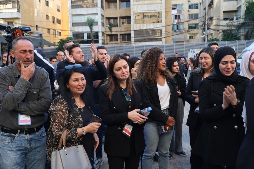 Colleagues of the Al-Mayadeen journalists mourn at the channel's building in Beirut