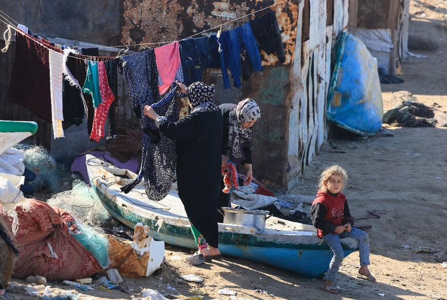 Palestinian women hang out their laundry to dry on the beach in Deir el-Balah. They make do with seawater as drinking water is far too scare to use for washing.