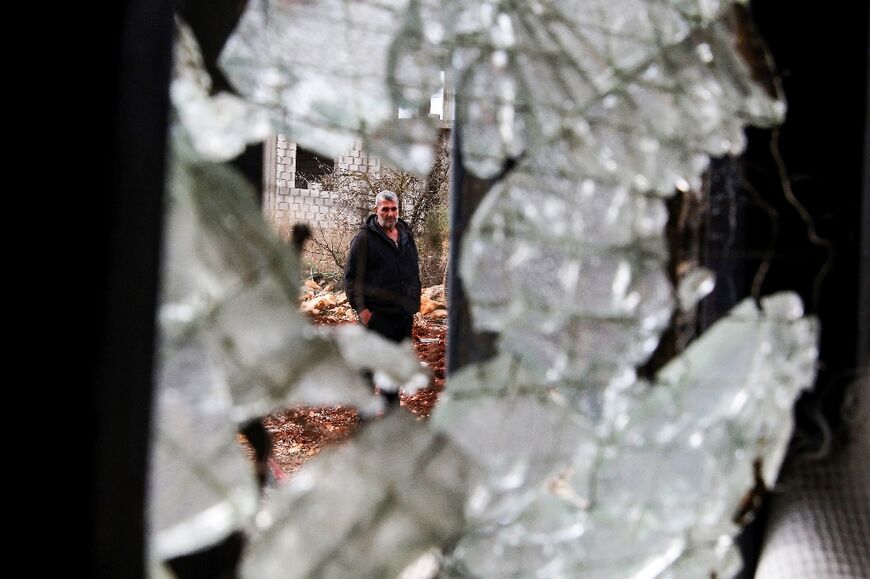 Lebanese farmer and minibus driver Abdallah Abdallah inspects his damaged home in Aitaroun, southern Lebanon near the Israeli border, on November 25, 2023