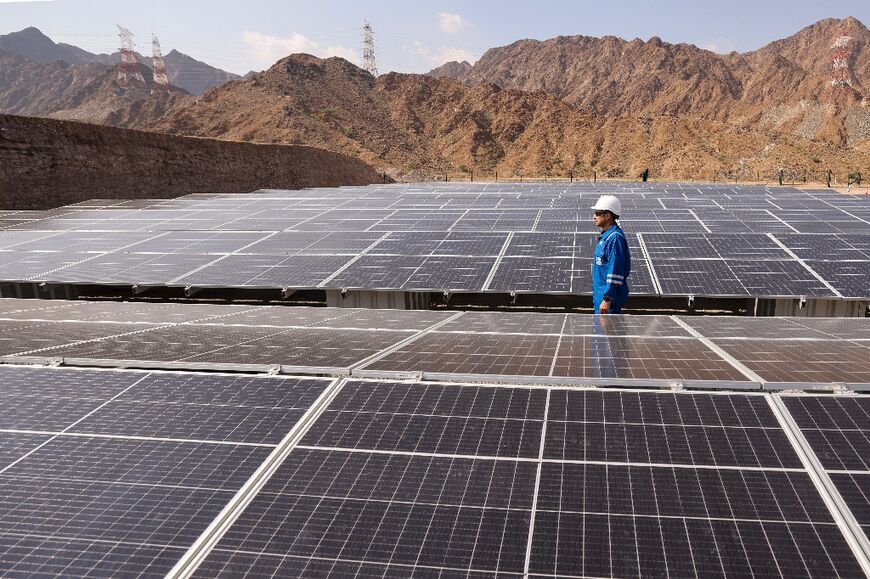 An engineer checks solar panels at the ADNOC carbon capture facility in the UAE