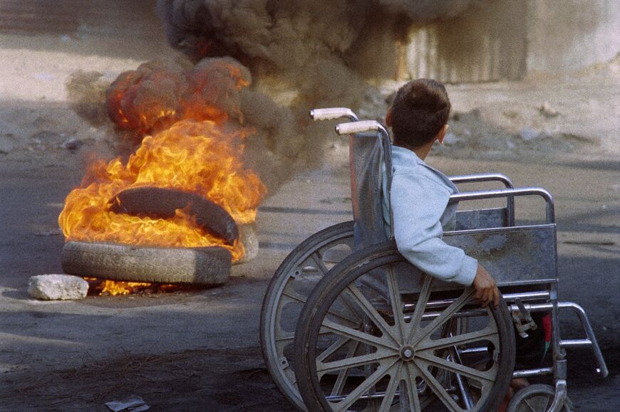 A young boy in a wheelchair moves around the Jabaliya refugee camp in Gaza
