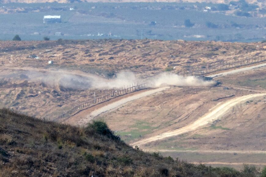 An Israeli tank crosses back into Israel from Gaza