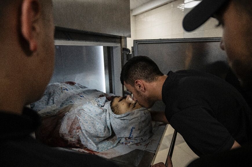 At a morgue in Jenin, the pale faces of young men were stained with blood