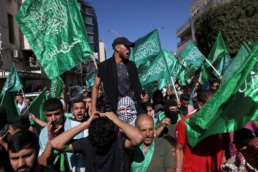 Palestinian supporters of the militant group Hamas rally in Hebron, the Israeli-occupied West Bank 