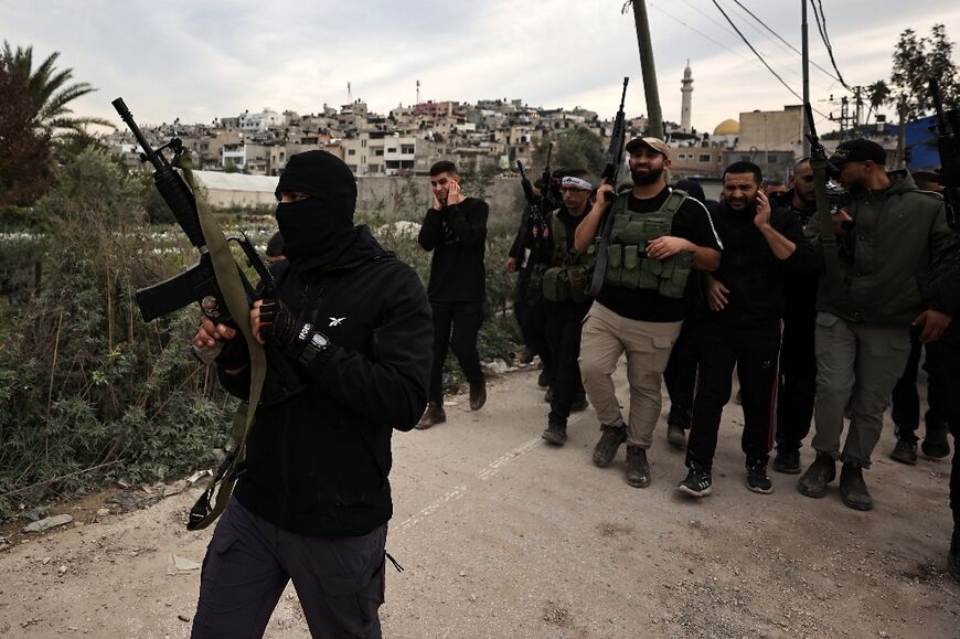 Violence has escalated in the occupied West Bank since the Gaza war broke out. This picture shows gunmen attend the funeral of five Palestinians killed during an Israeli raid at the Nur Shams camp in Tulkarm, on December 17, 2023