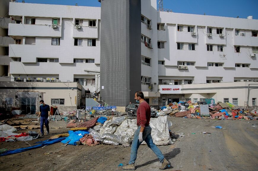 A Palestinian man walks near al-Shifa hospital in Gaza City on November 26