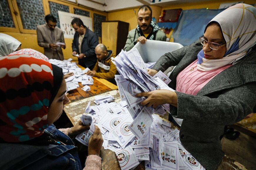 Election officials count votes at a polling station at Cairo's Abdeen district