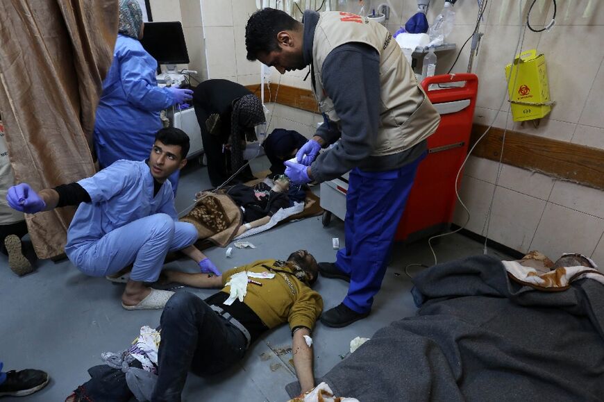 People injured in an Israeli bombardment receive medical care at the emergency ward of the al-Aqsa hospital in Deir al-Balah in the central Gaza Strip.