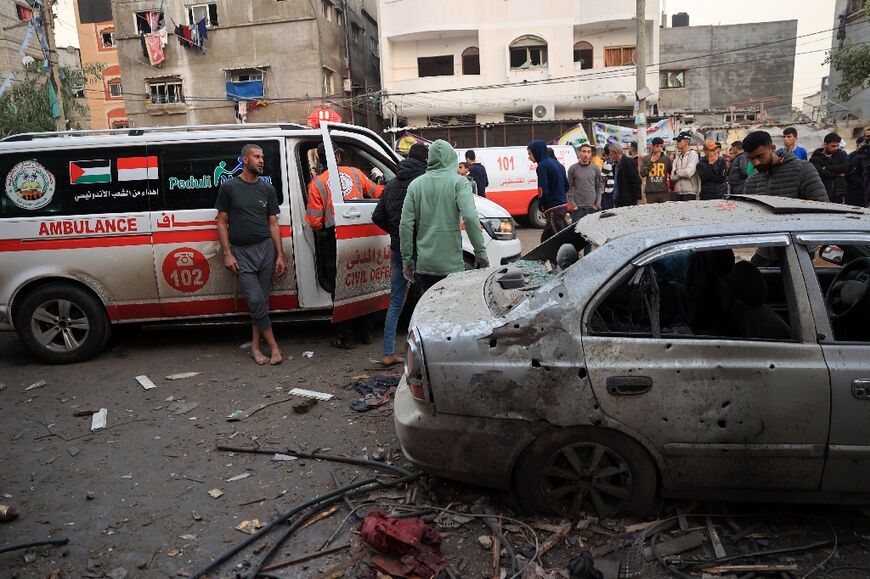 Palestinians gather near an ambulances following Israeli bombardment in Rafah