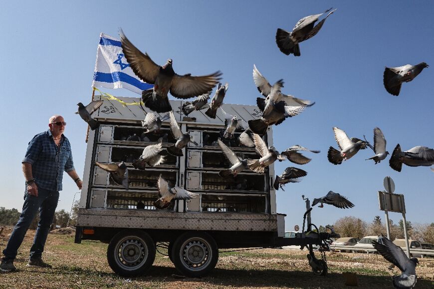 Ori Rosner, head of the Israel racing pigeons club, releases 140 birds to represent hostages still held by Hamas in Gaza 