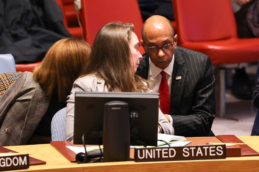 US deputy ambassador to the UN Robert Wood (R) talks with advisers during a United Nations Security Council meeting -- the divided body has grappled with the wording of a ceasefire resolution