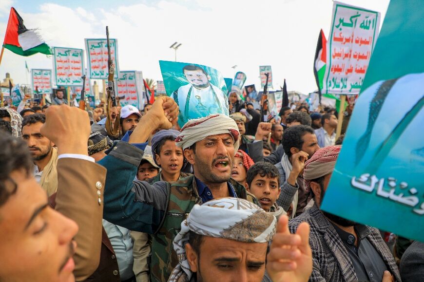 Yemenis brandishing their guns chant slogans during a march in solidarity with the people of Gaza in the Huthi-controlled capital Sanaa on December 15, 2023