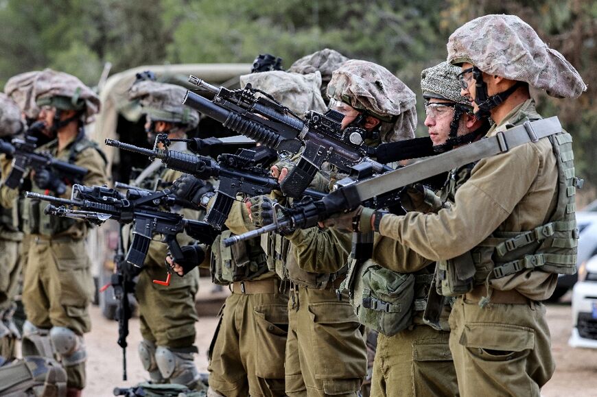 Israeli soldiers gather on the Israeli side of the Gaza border